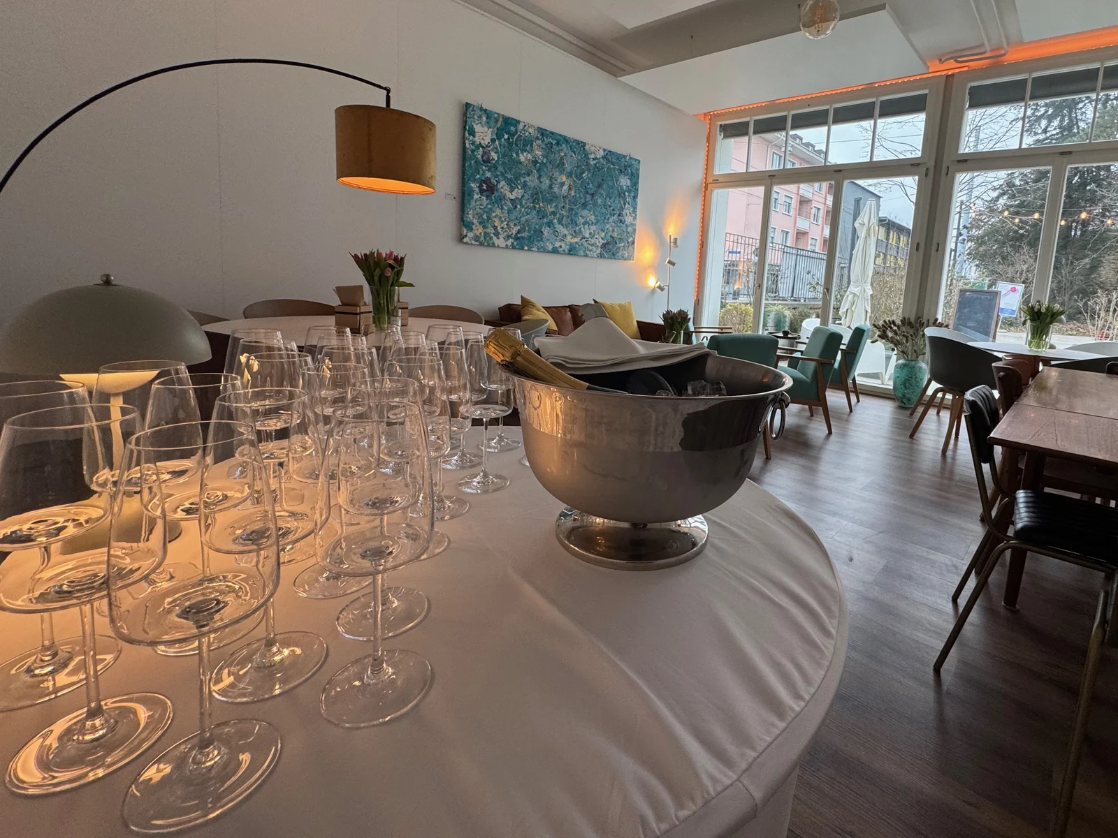 Event room at Pförtnerhaus with wine glasses and a champagne bucket, ready for an aperitif